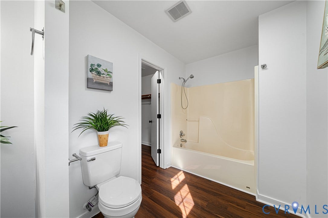 8414 Whirlaway Drive, Matoaca, Midlothian, VA 23112 Full bathroom featuring a toilet, a bathtub with an integrated shower, and wood-finish flooring