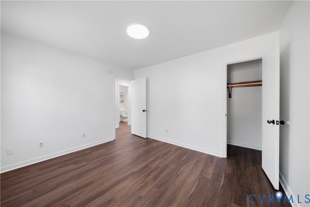 8414 Whirlaway Drive, Matoaca, Midlothian, VA 23112 Wood-finish flooring with white walls, a flush-mount ceiling light, and a built-in closet with shelving