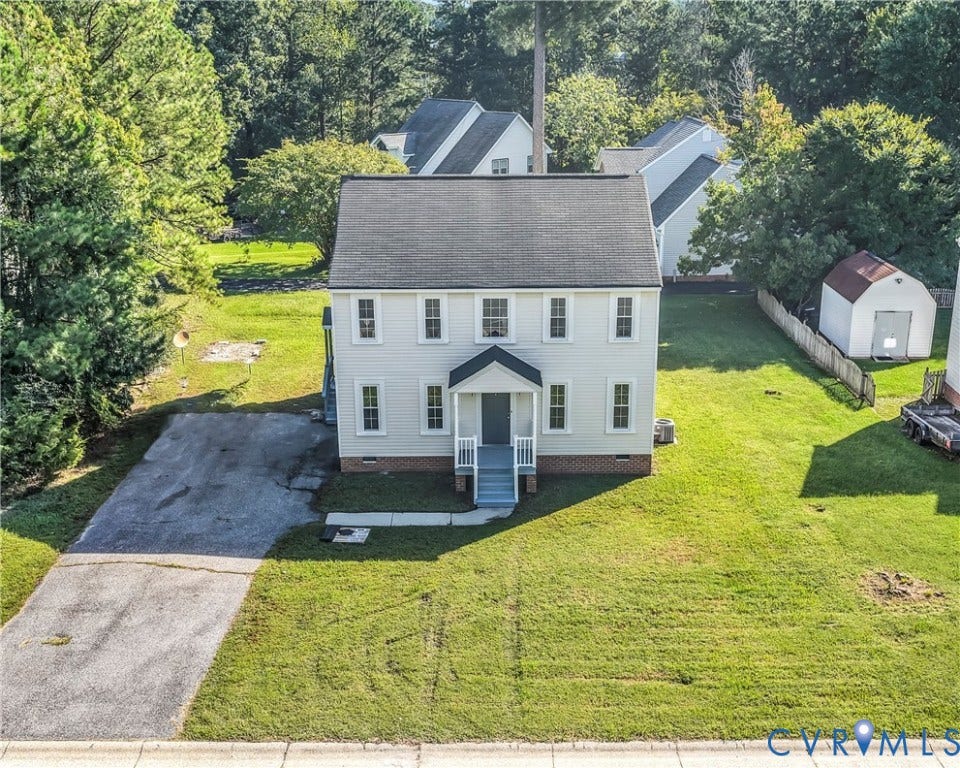 8414 Whirlaway Drive, Matoaca, Midlothian, VA 23112 Two-story colonial-style residence featuring a prominent front porch, a gabled roofline, and a paved driveway
