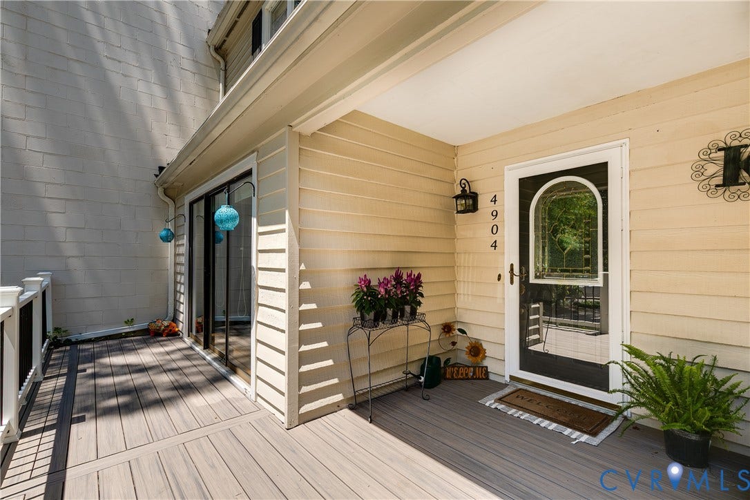 Covered porch entry featuring composite decking