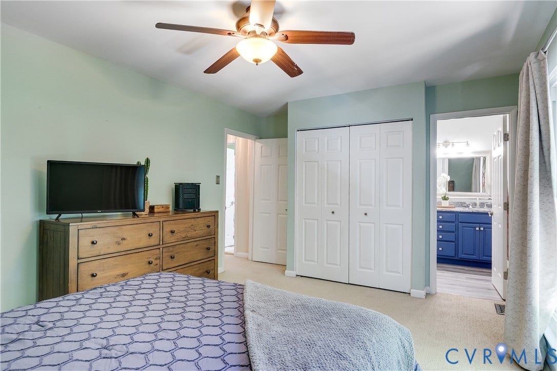 Carpeted room featuring light green walls and a ceiling fan with integrated lighting