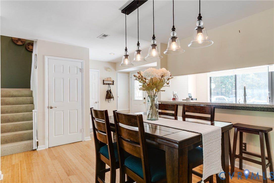 Open concept dining area featuring wood-finish flooring