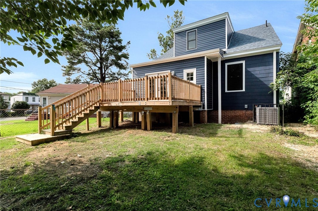 503 Pollock Street, Richmond, VA 23222 Rear exterior featuring blue siding, a wooden deck with railing, and a ground-level concrete step