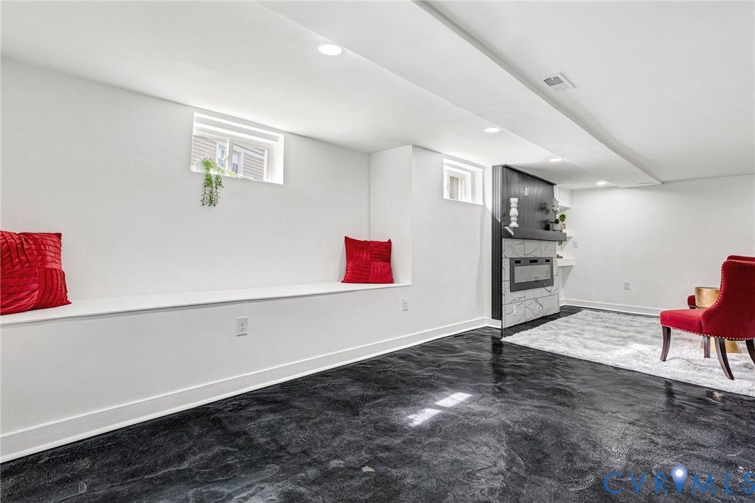 503 Pollock Street, Richmond, VA 23222 Recessed lighting illuminates the modern electric fireplace featuring a light-toned stone surround