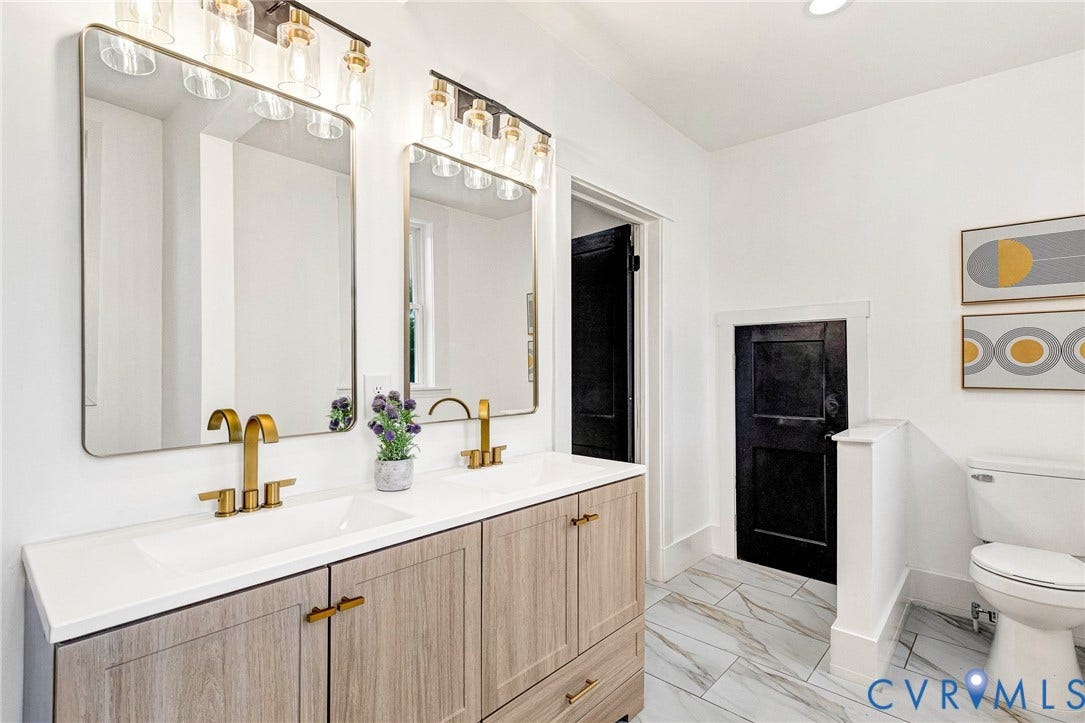 503 Pollock Street, Richmond, VA 23222 Double vanity with wood-finish cabinetry, white countertop, and gold-tone fixtures