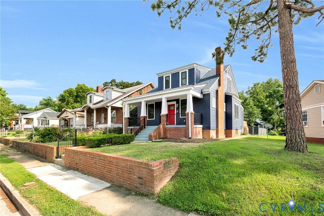 503 Pollock Street, Richmond, VA 23222 Crafted with a prominent brick chimney, this residence features a deep blue exterior and a welcoming front porch with white columns