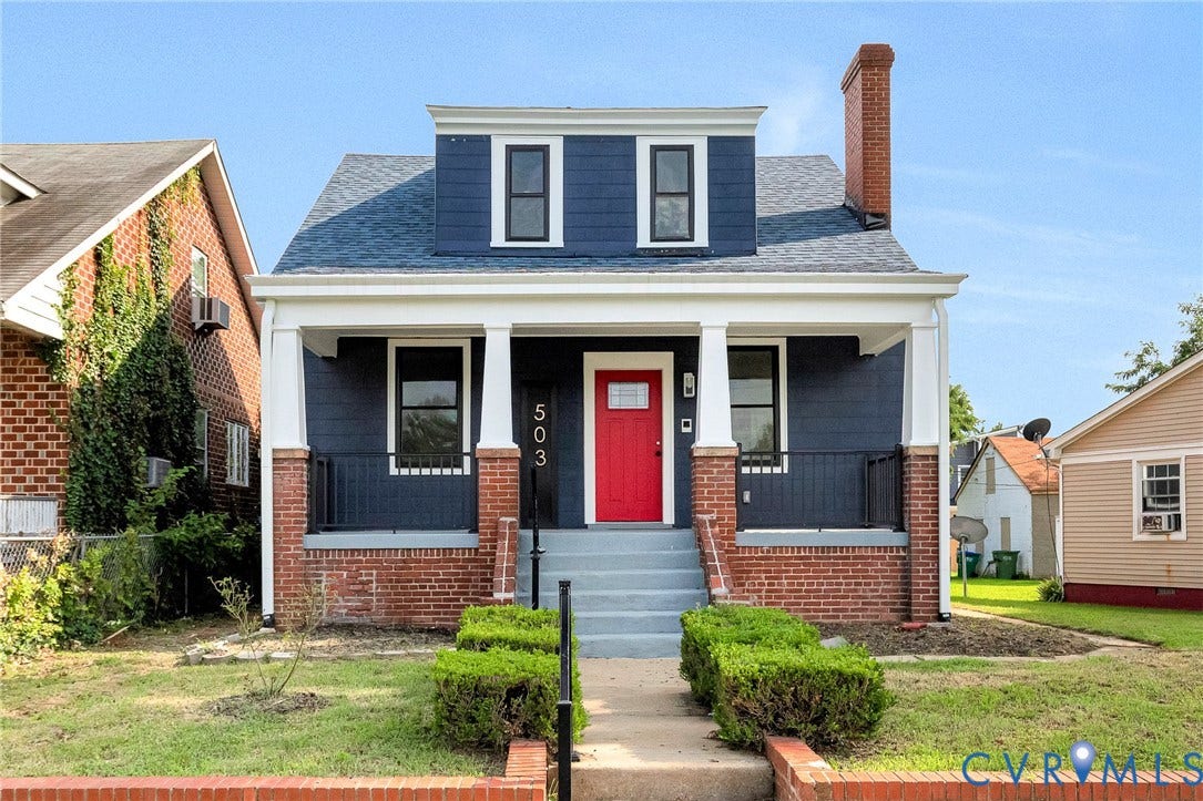 503 Pollock Street, Richmond, VA 23222 Exterior featuring a prominent red entry door, white columned porch, brick foundation, and dark siding with white trim