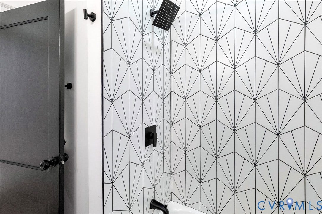 503 Pollock Street, Richmond, VA 23222 Shower featuring geometric tile, a matte black shower head, and coordinating matte black fixtures