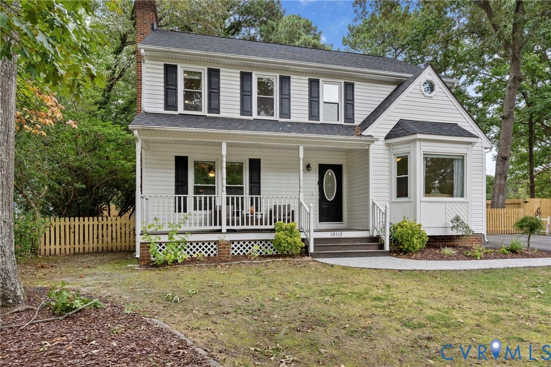 White siding exterior with black shutters and a covered front porch