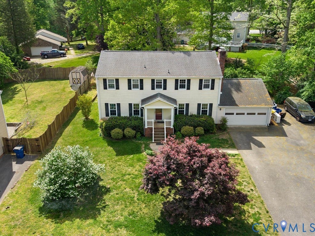 Two-story property with a two-car garage and a paved driveway