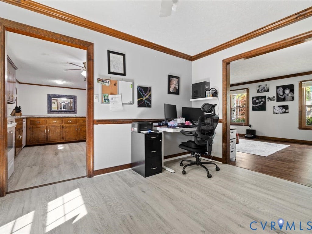 Light wood-finish flooring extending into adjacent spaces