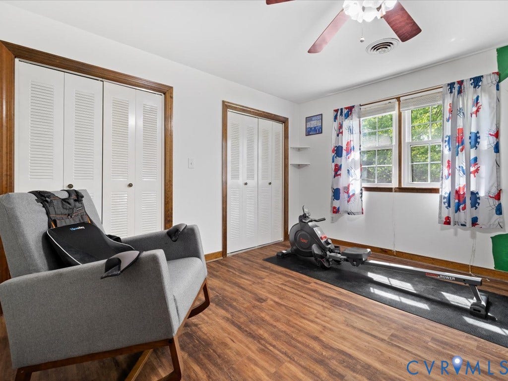 Wood-finish flooring with white walls and trim