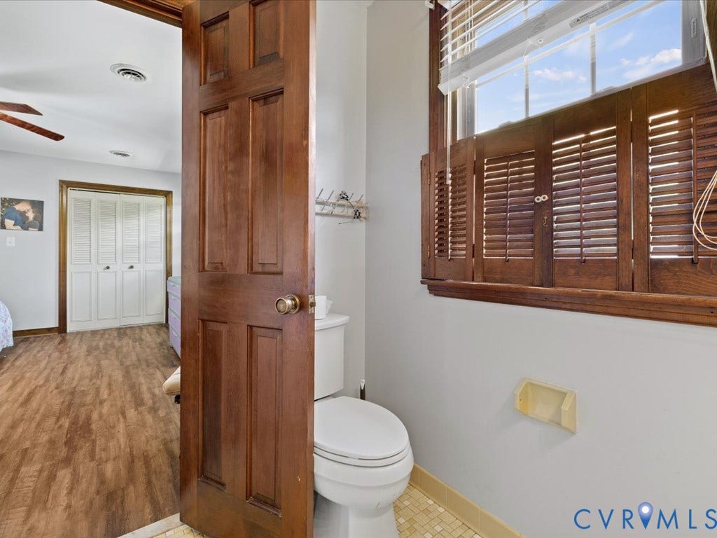 Rich wood-paneled door with brass hardware