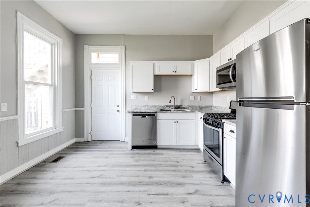 704 Chimborazo Boulevard, Chimborazo, Richmond, VA 23223 Kitchen featuring white cabinetry, stainless steel appliances, grey stone countertops, and wood-finish flooring