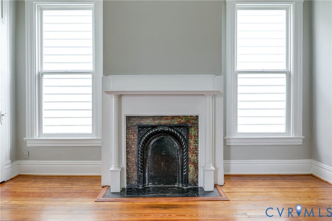 704 Chimborazo Boulevard, Chimborazo, Richmond, VA 23223 Ornate fireplace with a cast iron insert, stone surround, and classic white mantel