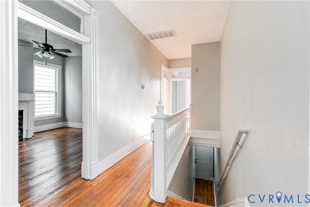 704 Chimborazo Boulevard, Chimborazo, Richmond, VA 23223 Hardwood flooring throughout, white painted trim, white painted balusters, and a ceiling fan with integrated lighting