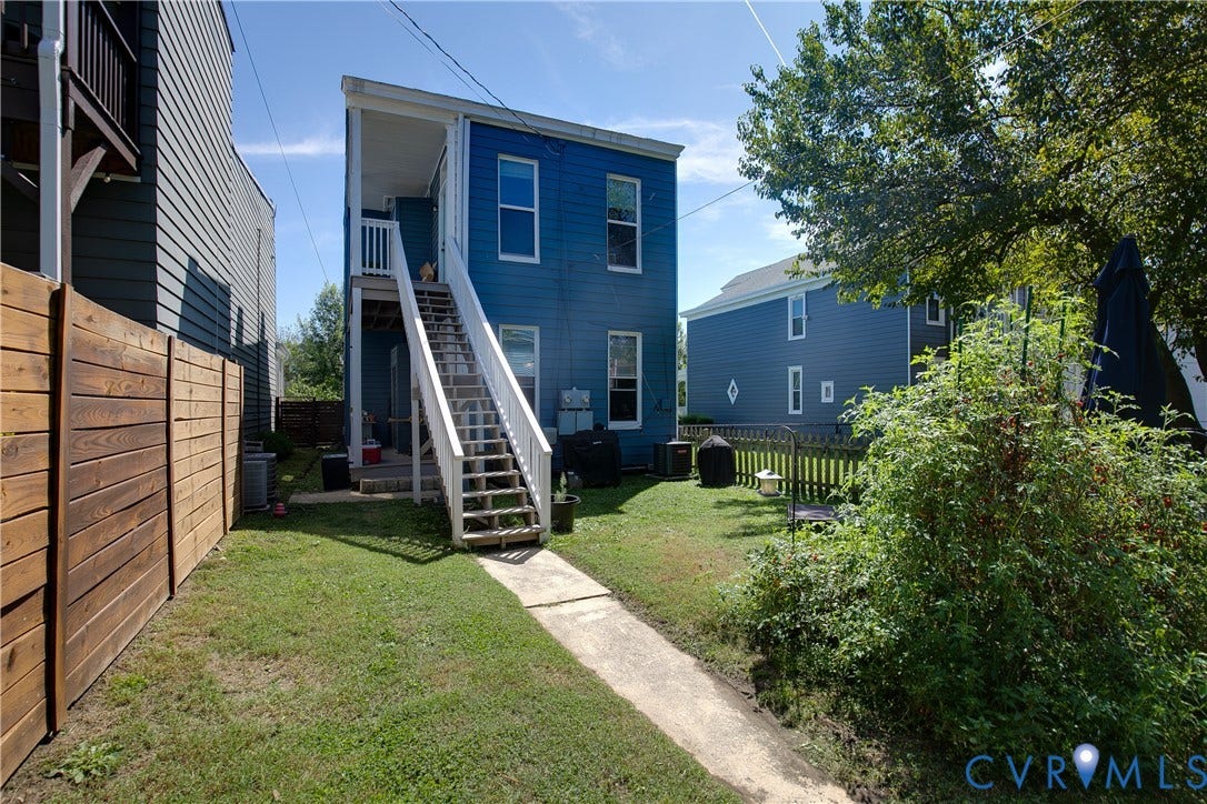 704 Chimborazo Boulevard, Chimborazo, Richmond, VA 23223 Exterior featuring blue siding, white trim, a multi-level deck with white railings, and a wood privacy fence