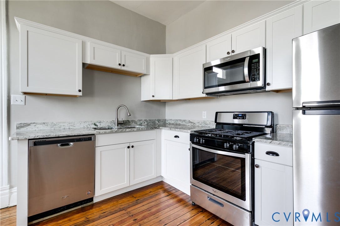 704 Chimborazo Boulevard, Chimborazo, Richmond, VA 23223 White shaker cabinetry, stainless steel appliances, granite countertops, and wood-finish flooring