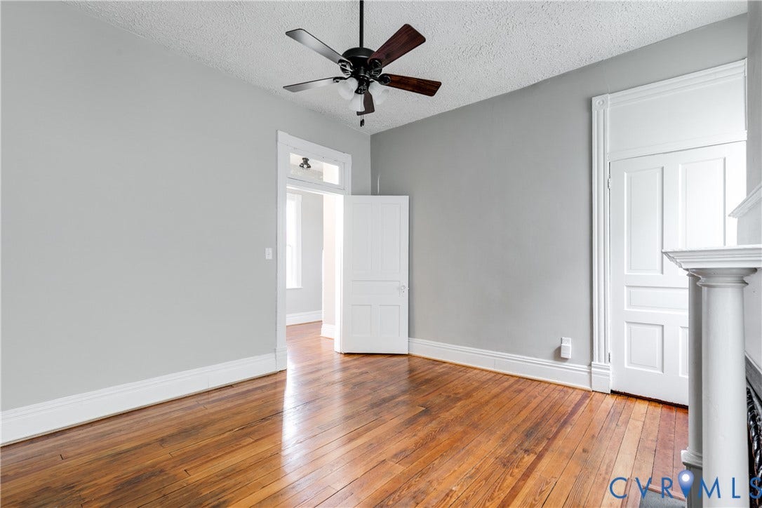 704 Chimborazo Boulevard, Chimborazo, Richmond, VA 23223 Hardwood flooring, painted walls, ceiling fan, white trim, and a paneled door