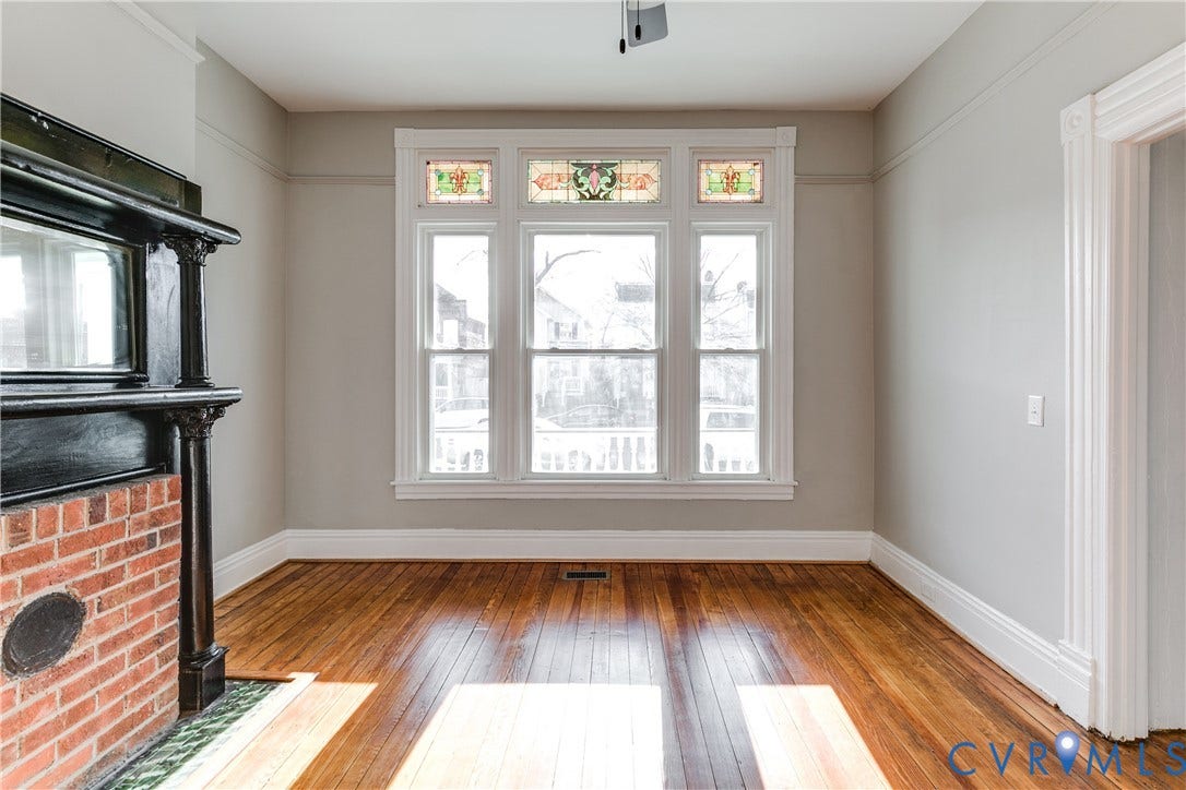 704 Chimborazo Boulevard, Chimborazo, Richmond, VA 23223 Original wood-finish flooring, brick fireplace with a decorative mantel, triple window with stained glass transoms, and extensive crown molding