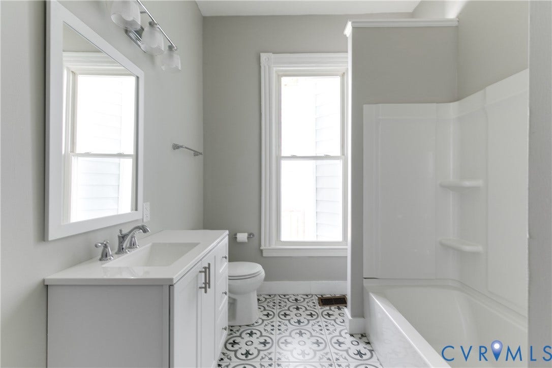 704 Chimborazo Boulevard, Chimborazo, Richmond, VA 23223 Bathroom featuring a single vanity with an integrated sink, polished chrome faucet, and a framed wall mirror