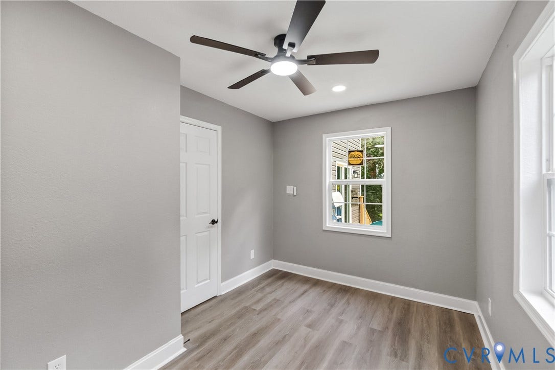 Recessed lighting, ceiling fan with integrated lighting, wood-finish flooring, white trim, and white paneled door