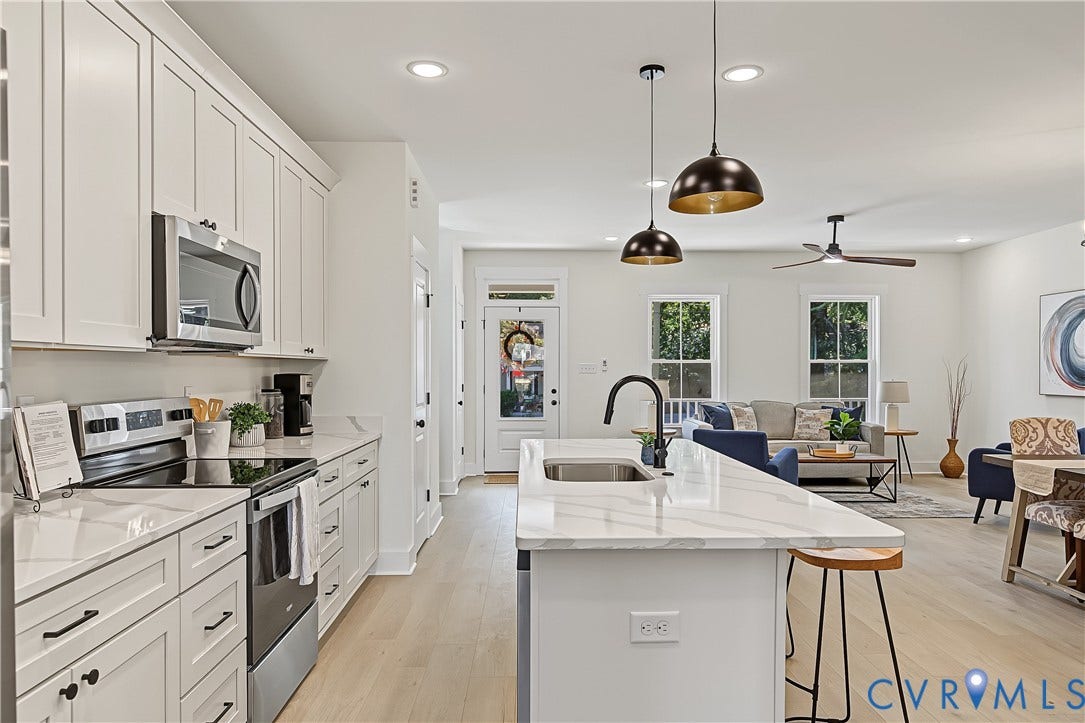 Open-concept living space with light wood-finish flooring