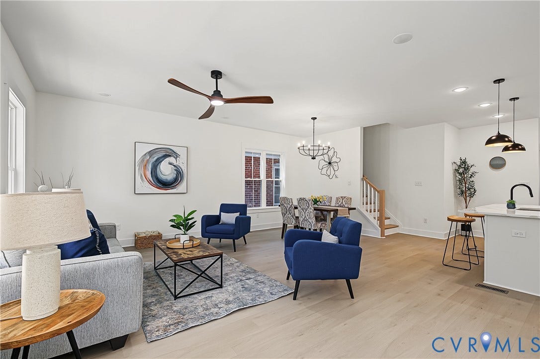 Open concept living area featuring light wood-finish flooring, recessed lighting, and a modern ceiling fan