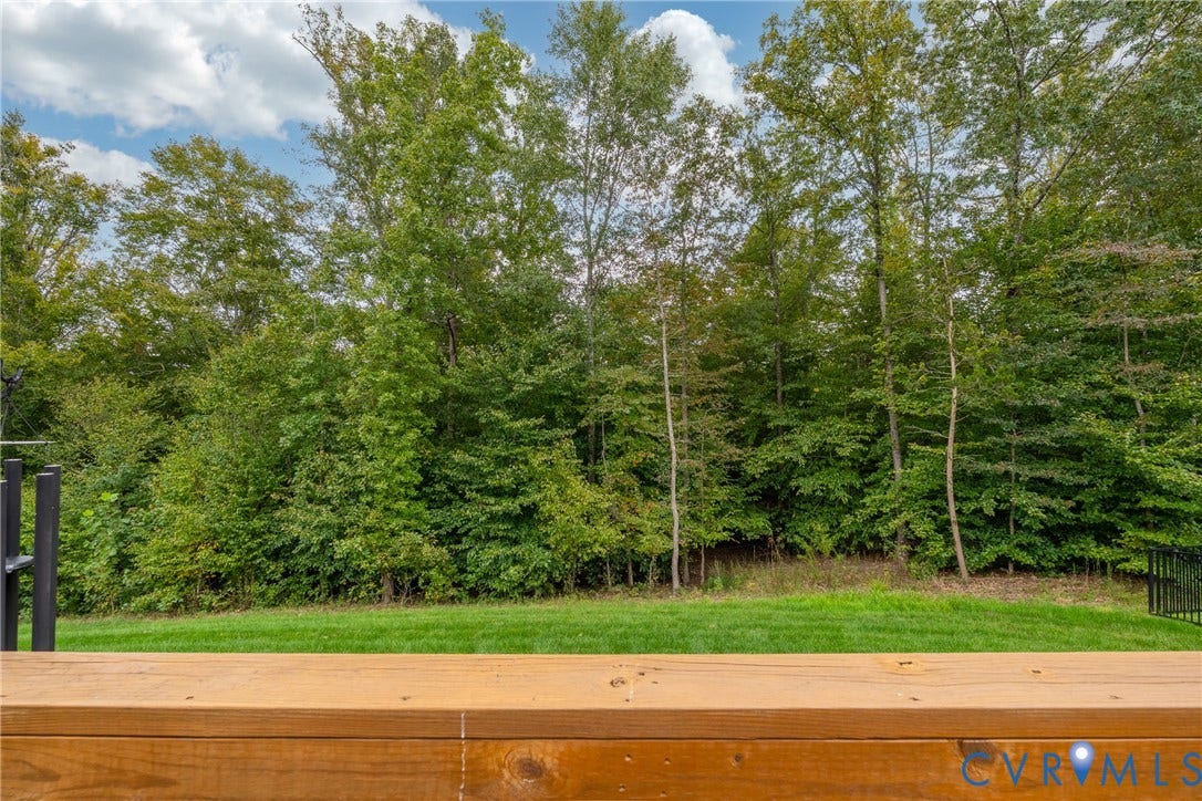12303 Beech Hall Circle, Manakin Sabot, VA 23103 Wood-finish deck railing with a grassy area and mature trees