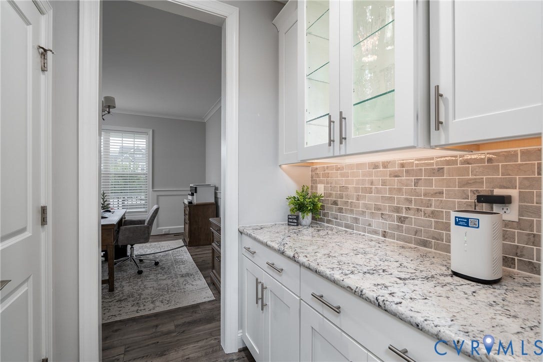 12303 Beech Hall Circle, Manakin Sabot, VA 23103 White shaker-style cabinetry with glass-front display cabinets, under-cabinet lighting, and a subway tile backsplash