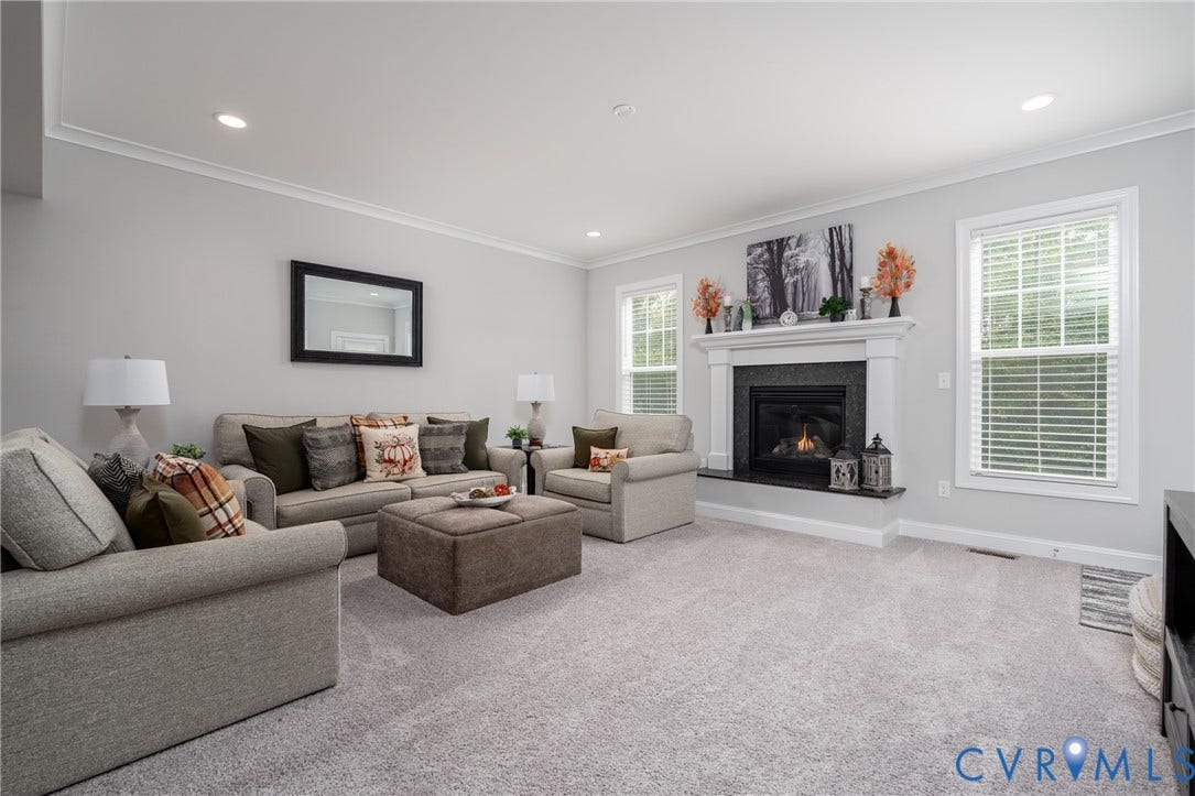 12303 Beech Hall Circle, Manakin Sabot, VA 23103 Recessed lighting, crown molding, light gray wall paint, fireplace with dark stone surround and white mantel, and light gray carpeting