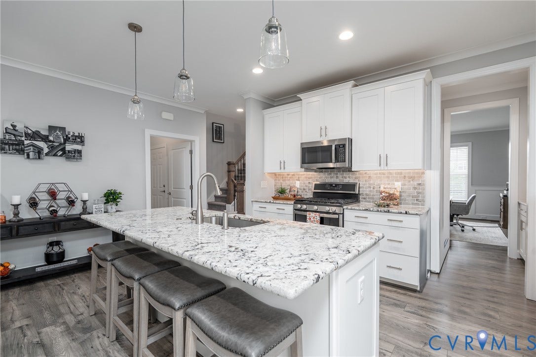 12303 Beech Hall Circle, Manakin Sabot, VA 23103 Kitchen featuring a large island with sink, stainless steel appliances, white cabinetry, tile backsplash, and wood-finish flooring