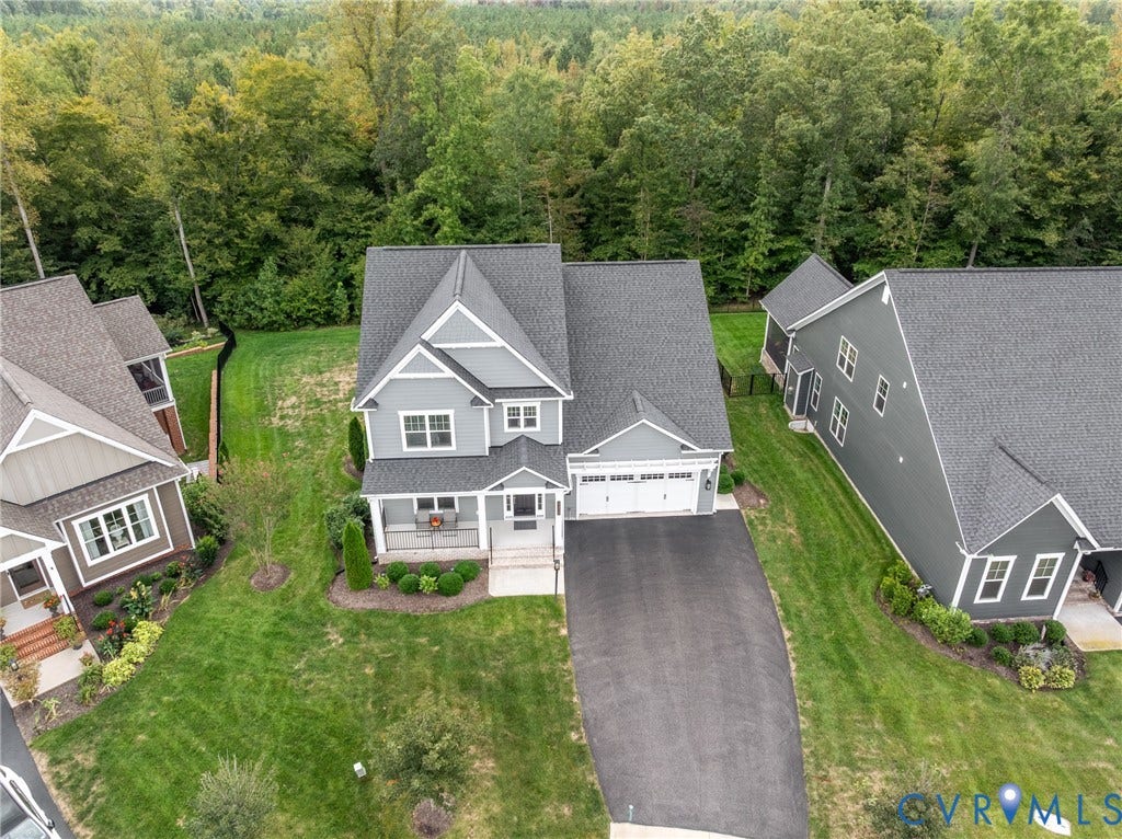 12303 Beech Hall Circle, Manakin Sabot, VA 23103 Two-story residence featuring a covered front porch, attached two-car garage, and a paved driveway