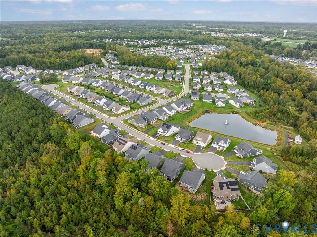 12303 Beech Hall Circle, Manakin Sabot, VA 23103 Residential community featuring a prominent pond with a fountain, surrounded by mature trees