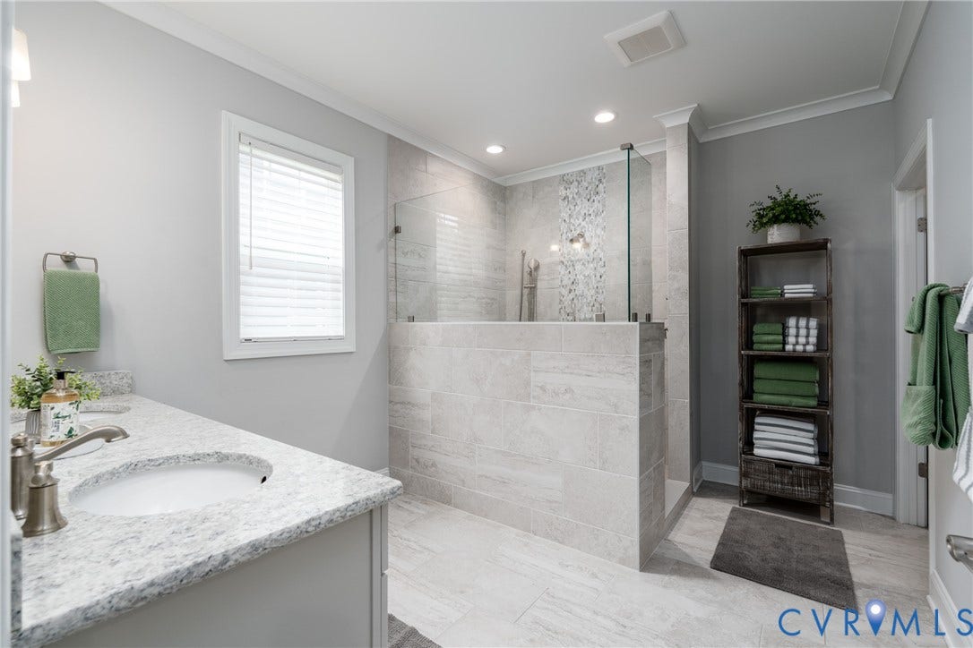 12303 Beech Hall Circle, Manakin Sabot, VA 23103 Spacious bathroom featuring a walk-in shower with glass enclosure, tiled accent wall, and light-toned tile flooring