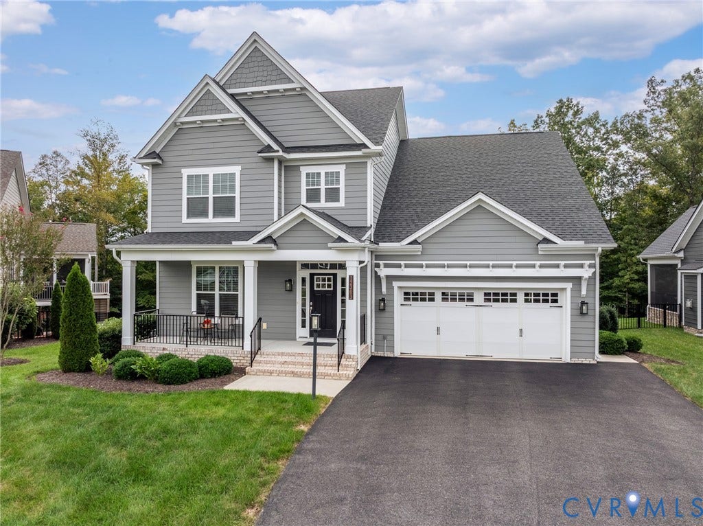 12303 Beech Hall Circle, Manakin Sabot, VA 23103 Gray siding exterior with white trim, a covered porch, a two-car garage, an asphalt driveway, and mature landscaping