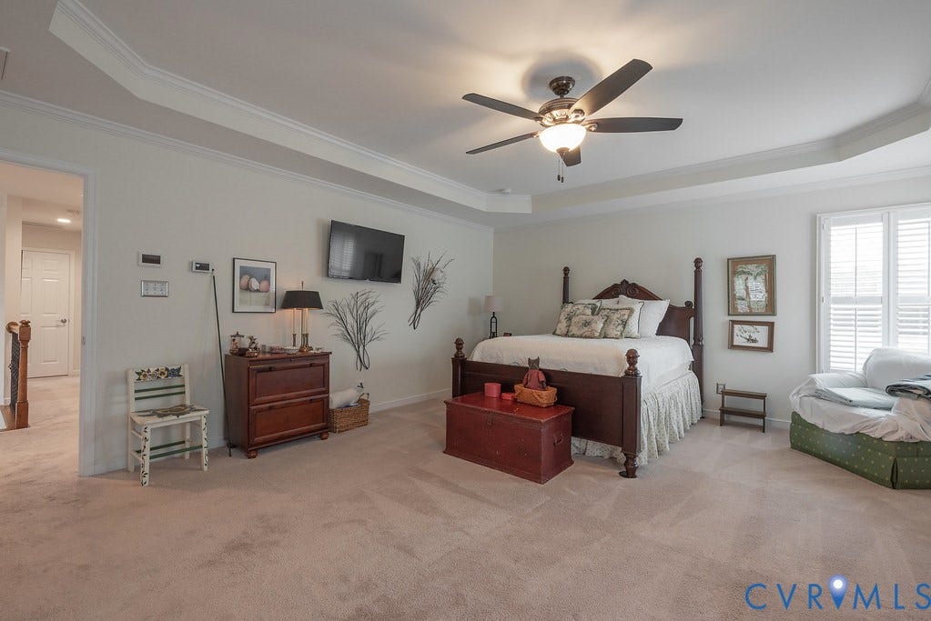6301 Broad Sky Circle, Quiet, Mechanicsville, VA 23111 Tray ceiling with crown molding, ceiling fan, and plantation shutters