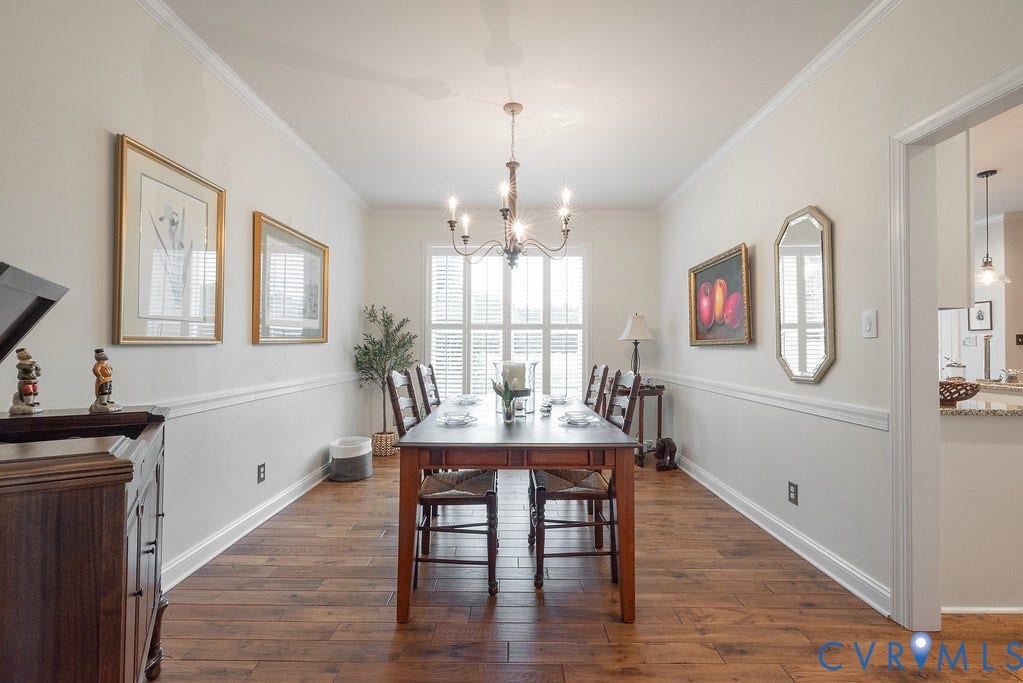 6301 Broad Sky Circle, Quiet, Mechanicsville, VA 23111 Wood-finish flooring, crown molding, chair rail detailing, recessed window with plantation shutters, and a chandelier lighting fixture