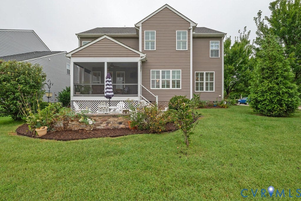 6301 Broad Sky Circle, Quiet, Mechanicsville, VA 23111 Backyard featuring a screened porch, stone retaining wall, and mature landscaping