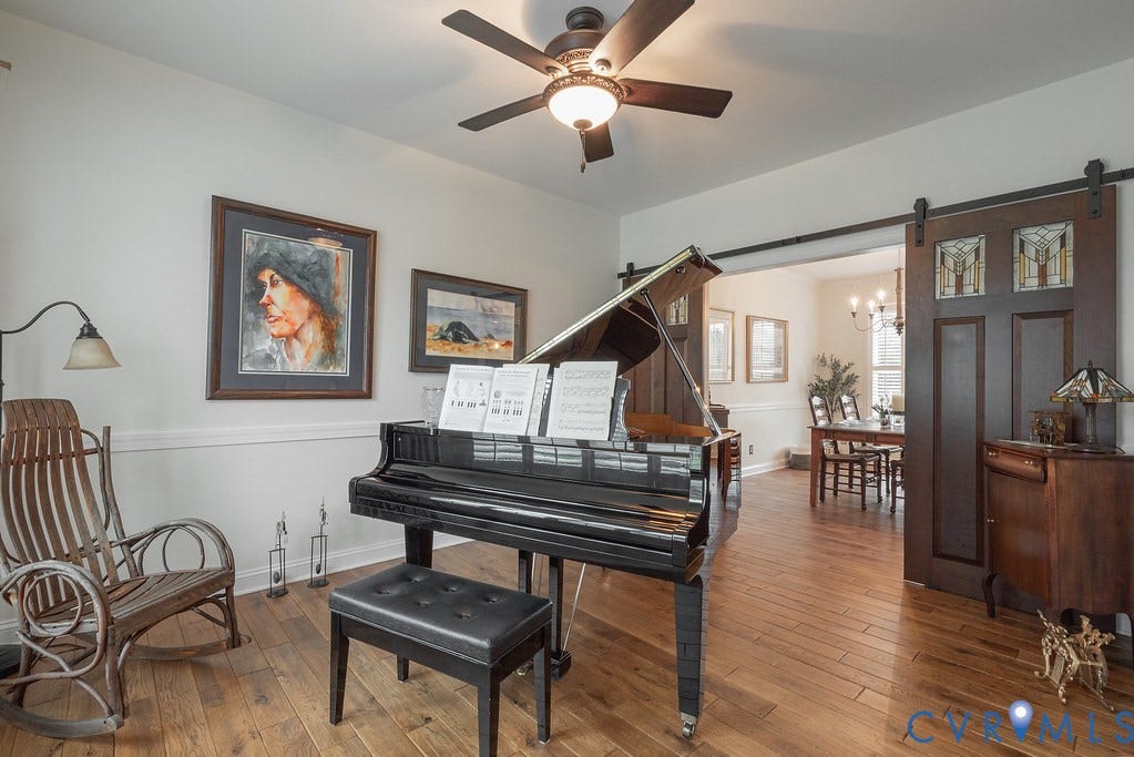 6301 Broad Sky Circle, Quiet, Mechanicsville, VA 23111 Hardwood flooring, crown molding, ceiling fan with integrated lighting, and a sliding barn door with decorative glass panels
