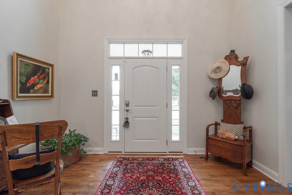 6301 Broad Sky Circle, Quiet, Mechanicsville, VA 23111 Hardwood-style flooring throughout the entry, a vaulted ceiling, and a transom window with sidelights surrounding the entry door