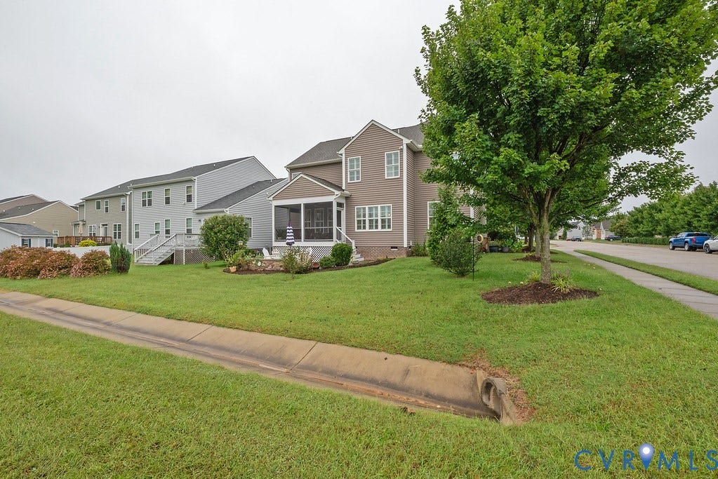 6301 Broad Sky Circle, Quiet, Mechanicsville, VA 23111 Two-story exterior with a screened porch, multiple windows, and a mature tree