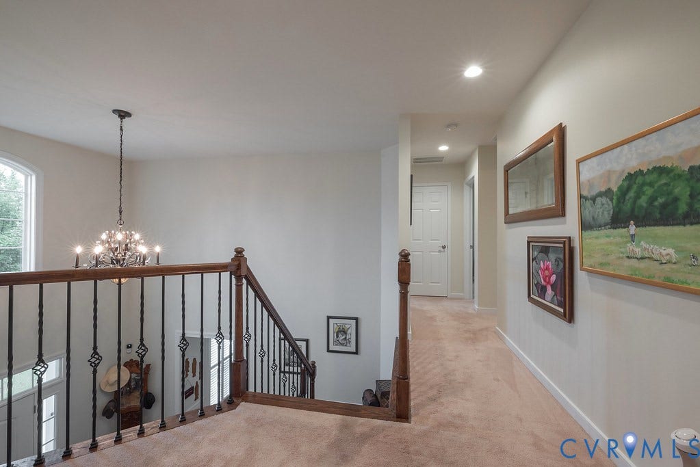 6301 Broad Sky Circle, Quiet, Mechanicsville, VA 23111 Upper landing with carpeted flooring, recessed lighting, and a chandelier with a decorative iron baluster