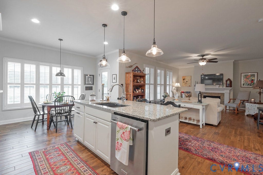 6301 Broad Sky Circle, Quiet, Mechanicsville, VA 23111 Open-concept living space featuring wood-finish flooring, a kitchen island with stone countertop, and recessed lighting