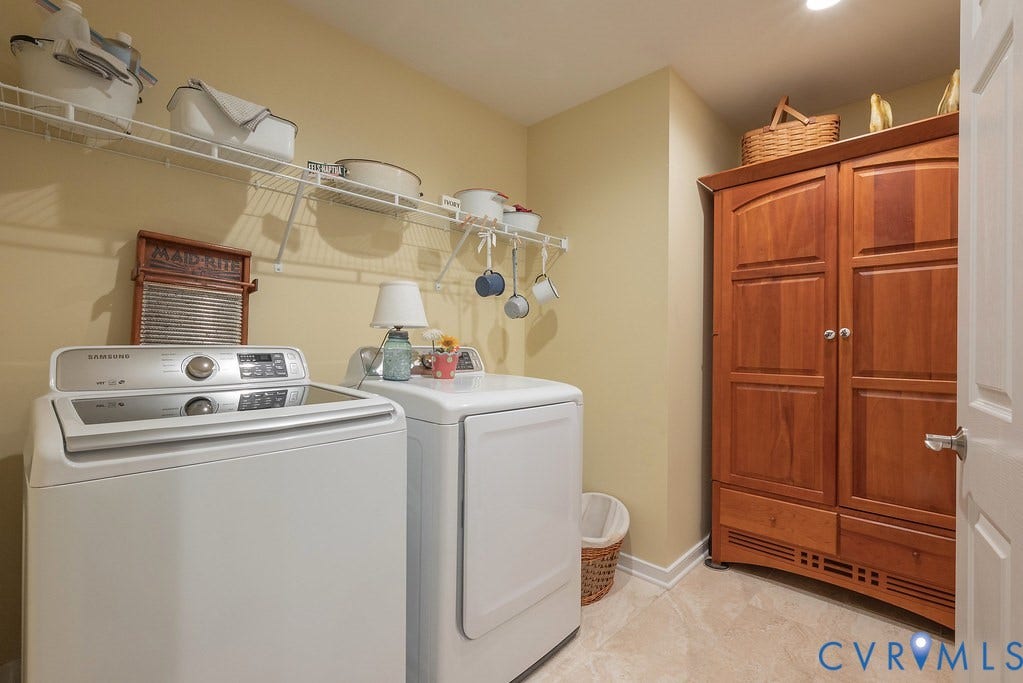 6301 Broad Sky Circle, Quiet, Mechanicsville, VA 23111 Laundry room featuring white wire shelving, recessed lighting, wood-finish cabinetry, and light-toned flooring
