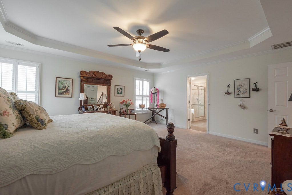6301 Broad Sky Circle, Quiet, Mechanicsville, VA 23111 Tray ceiling with crown molding, ceiling fan, carpeted flooring, and white paneled doors
