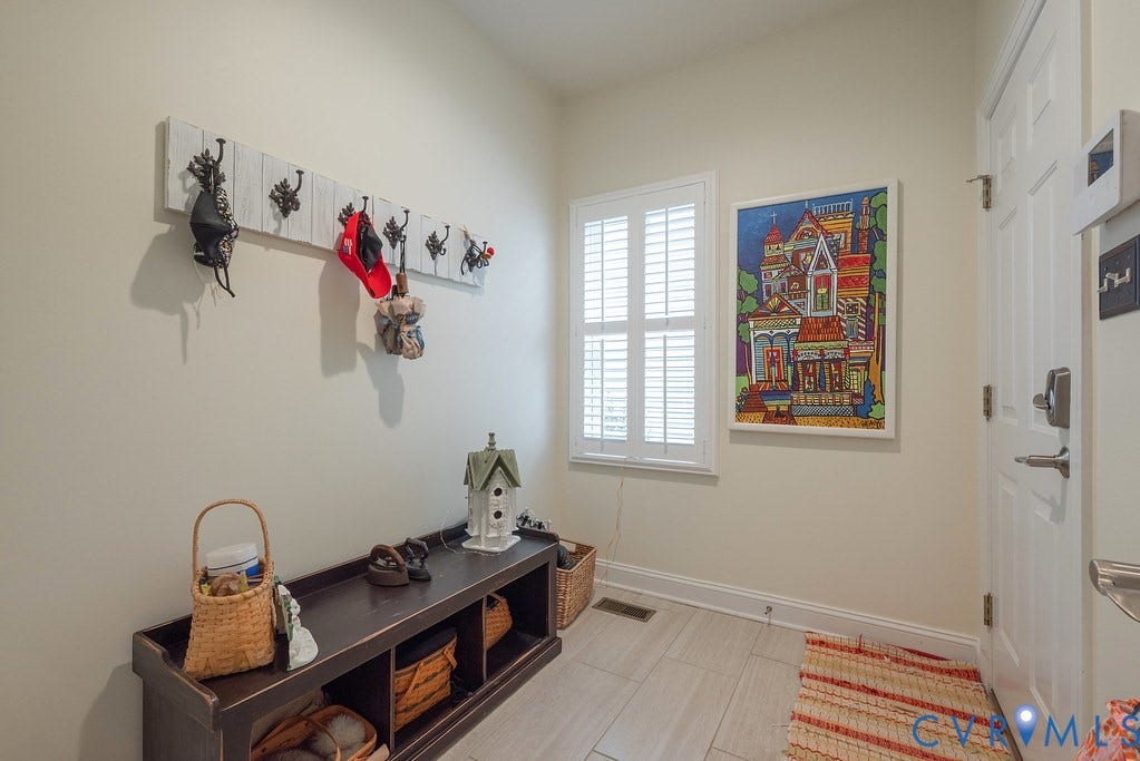 6301 Broad Sky Circle, Quiet, Mechanicsville, VA 23111 Window with plantation shutters, wood-finish flooring, and a solid entry door