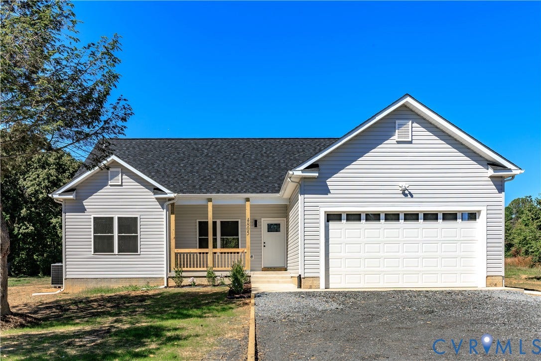 4805 Indian Creek Road, Mineral, VA 23117 Single-story residence featuring light gray siding, an attached garage, a covered front porch with wood railings, and a dark shingled roof