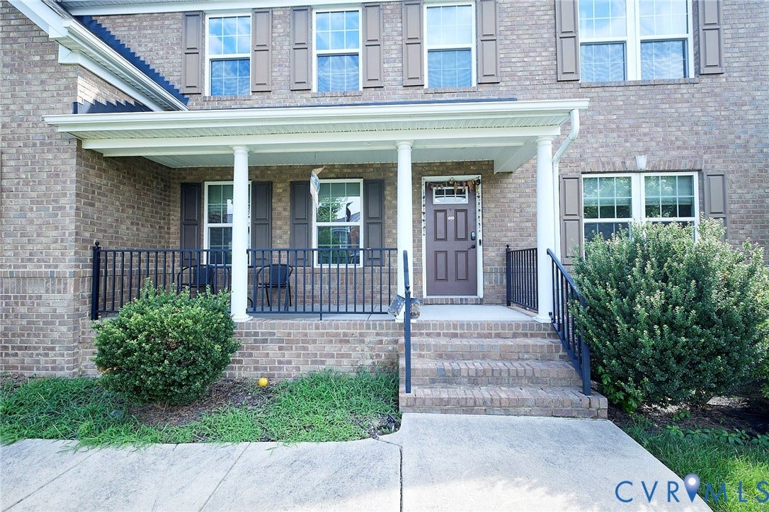 Brick facade with white-trimmed windows and dark shutters