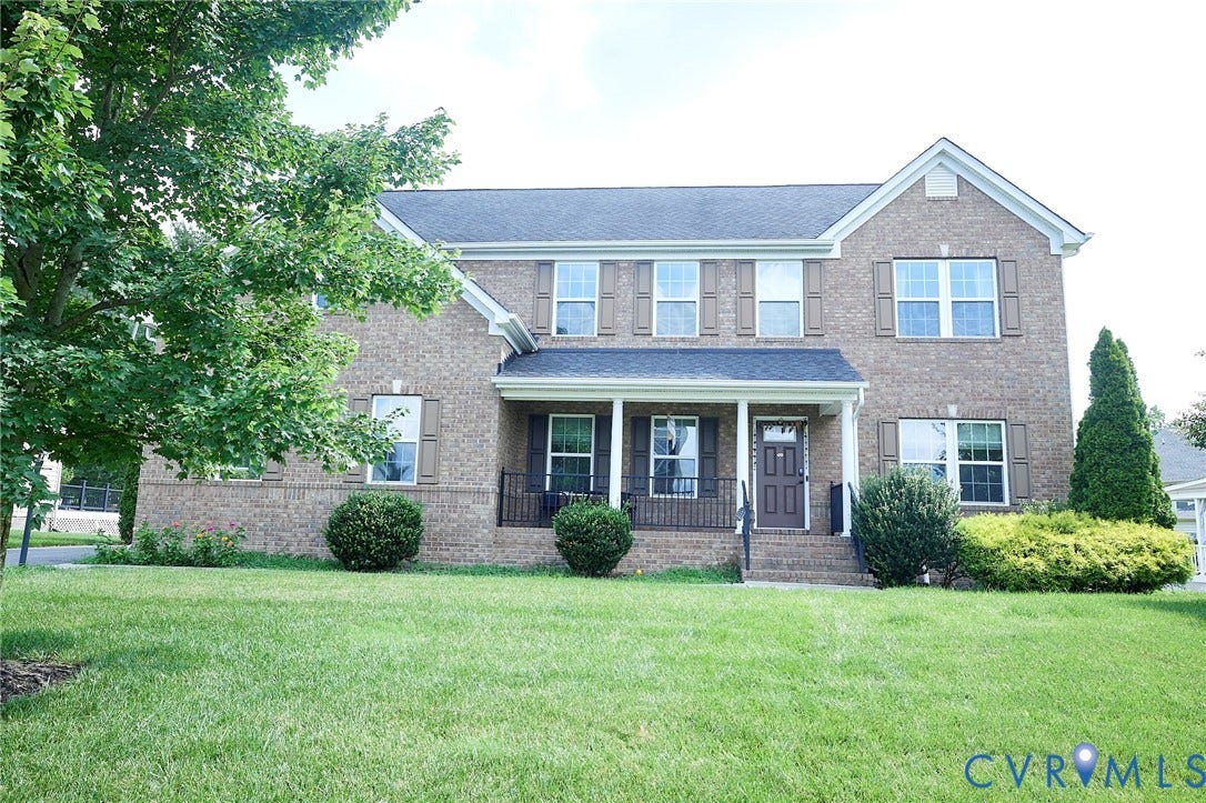 Brick facade with white trim and dark shutters